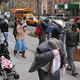 Citizens implicated in the scandal conceal their faces on a New York City street Tuesday.